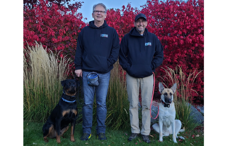Bart Merrell and Jeff Belnap with their trained dogs in northern Utah